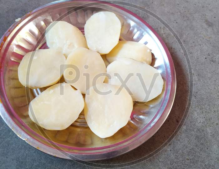 Boiled potatoes on steel plate.