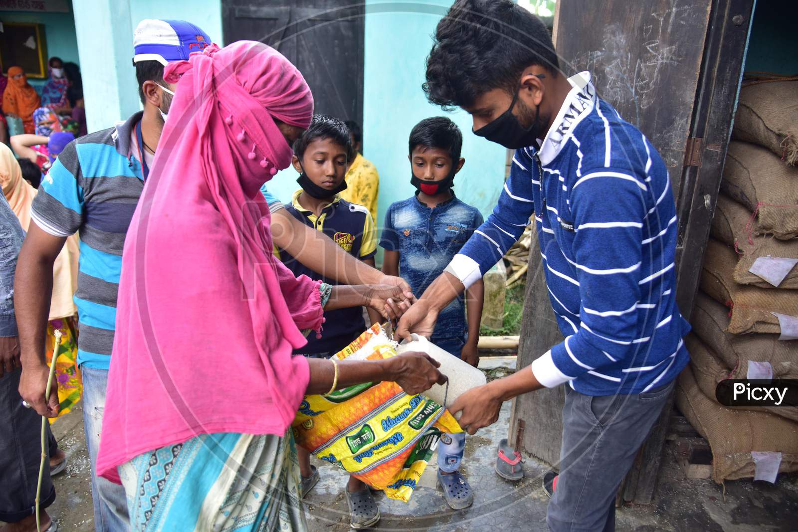 Volunteers Distribute Free Rice And Money Among School Students During Nationwide Lockdown Amidst Coronavirus Or COVID-19 Pandemic in Nagaon on May 14 2020