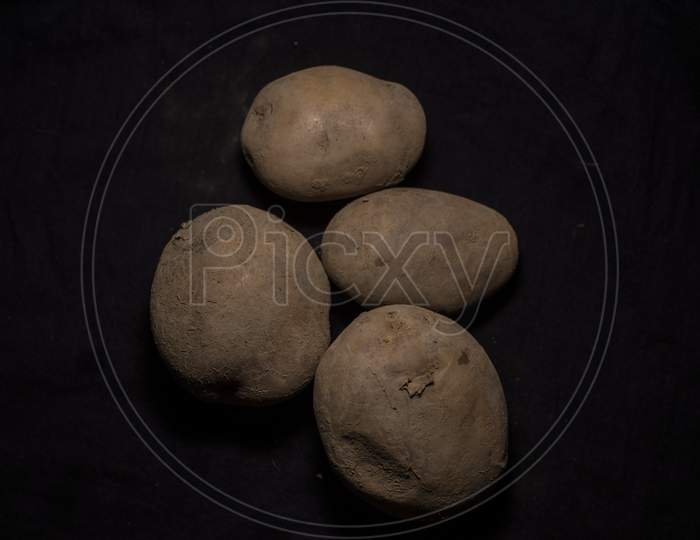 Top Down Image Of A Collection Of Potato In Dark Copy Space Background. Food And Product Photography.