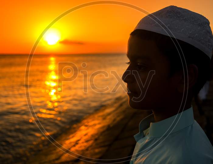 Bangladesh – June 22, 2019: A Boy Stands By The River Watching The Evening Sunset At Chandpur, Bangladesh.