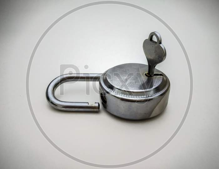 Steel Lock And Key Close Up Shot Isolated In White Background.