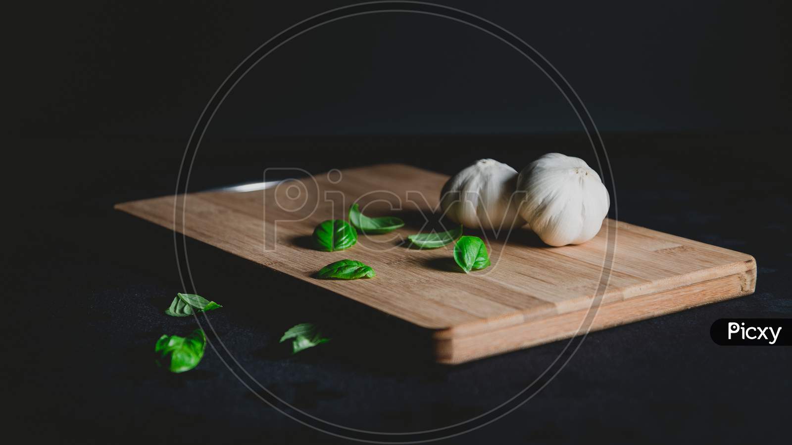 Natural Organic whole Garlic on wooden plate