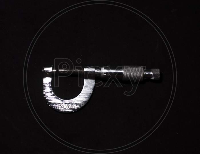 A Screw Gauge In The Dark Copy Space Background. Product Photography.