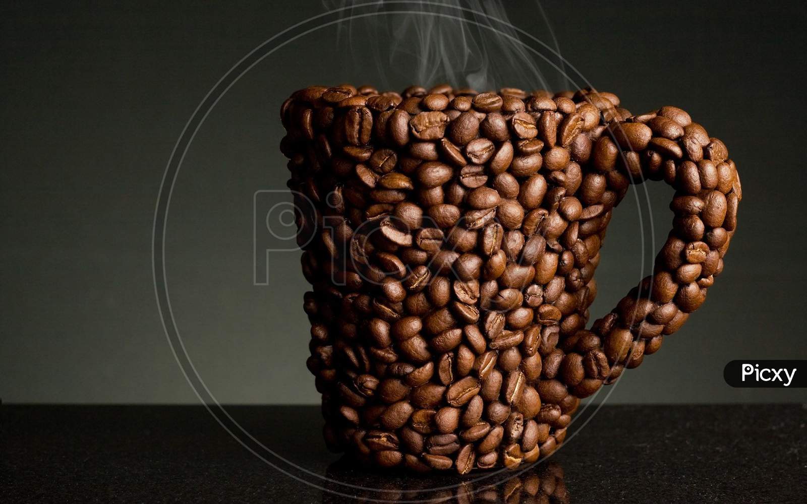 Coffee mug made up of Coffee beans in black background