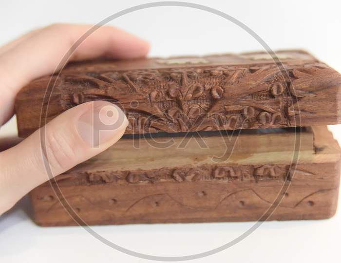 Hand On The Carved Wooden Box