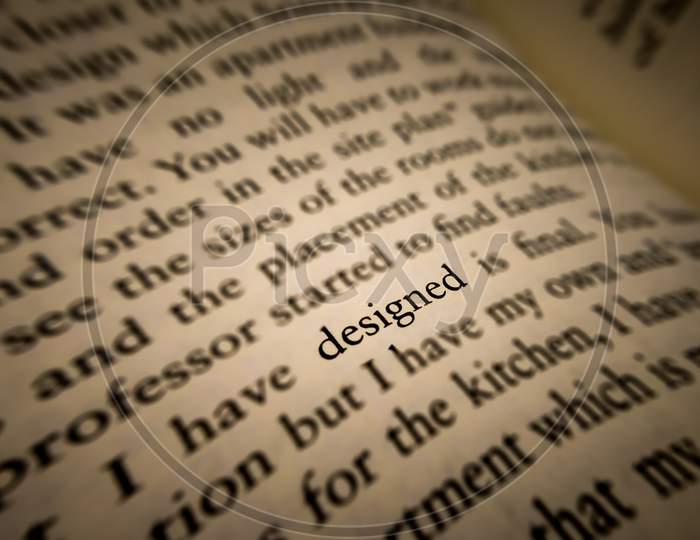 Designed Word Highlighted And Focused In An Old Book.