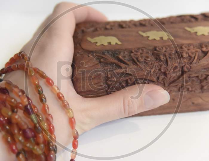 Hand On The Carved Wooden Box. Selective Focus
