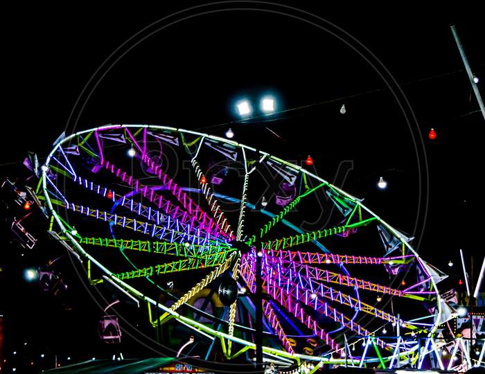 Night View of Amusement park rides, Ferris Wheel in diwali fair