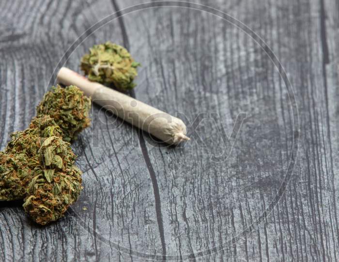 Buds Of Medical Marijuana And Joint On Table