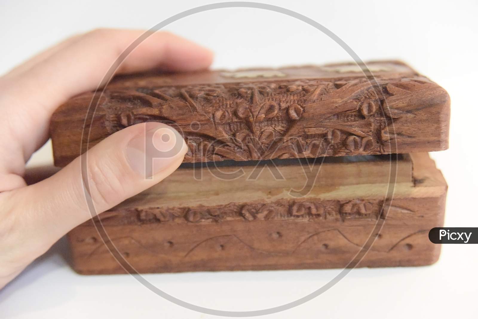 Hand On The Carved Wooden Box