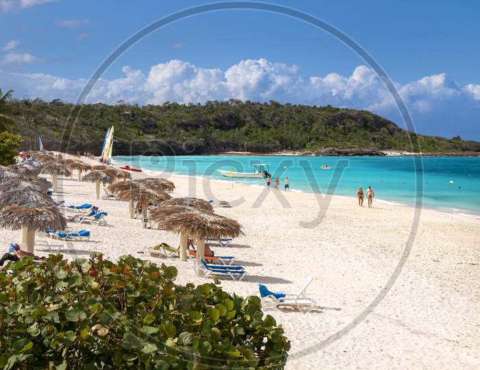 Caribbean beach showing coast with white sand turquoise sea and blue sky