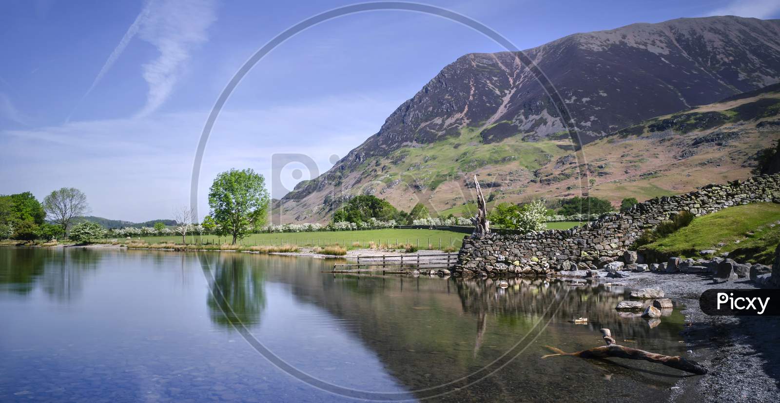 The south edge of Crummock Water on a calm morning with Rannerdale in the background.