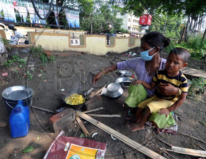 A Homeless Woman Cooks Food At A Roadside During Nationwide Lockdown Amidst Coronavirus or COVID-19 Pandemic  In Guwahati District Of Assam,India