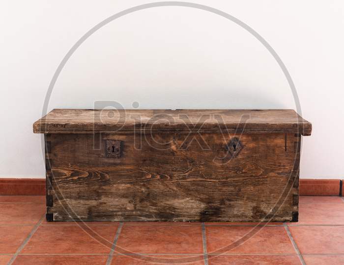 Old wooden chest with two metal locks in a white background