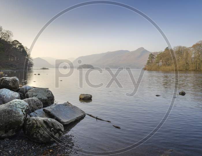 The Early morning still, calm water of Derwent water at Keswick in the Cumbrian Lake District in the North of England.
