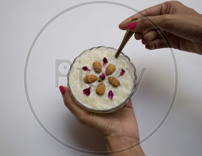Female Hand Holding Bowl Filled With Kheer