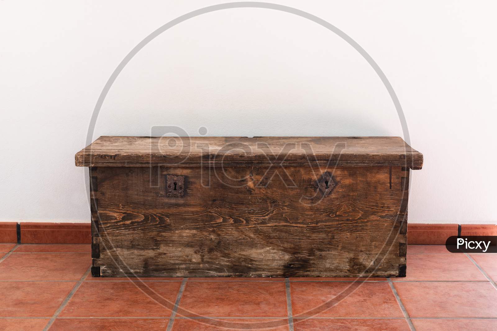 Old wooden chest with two metal locks in a white background