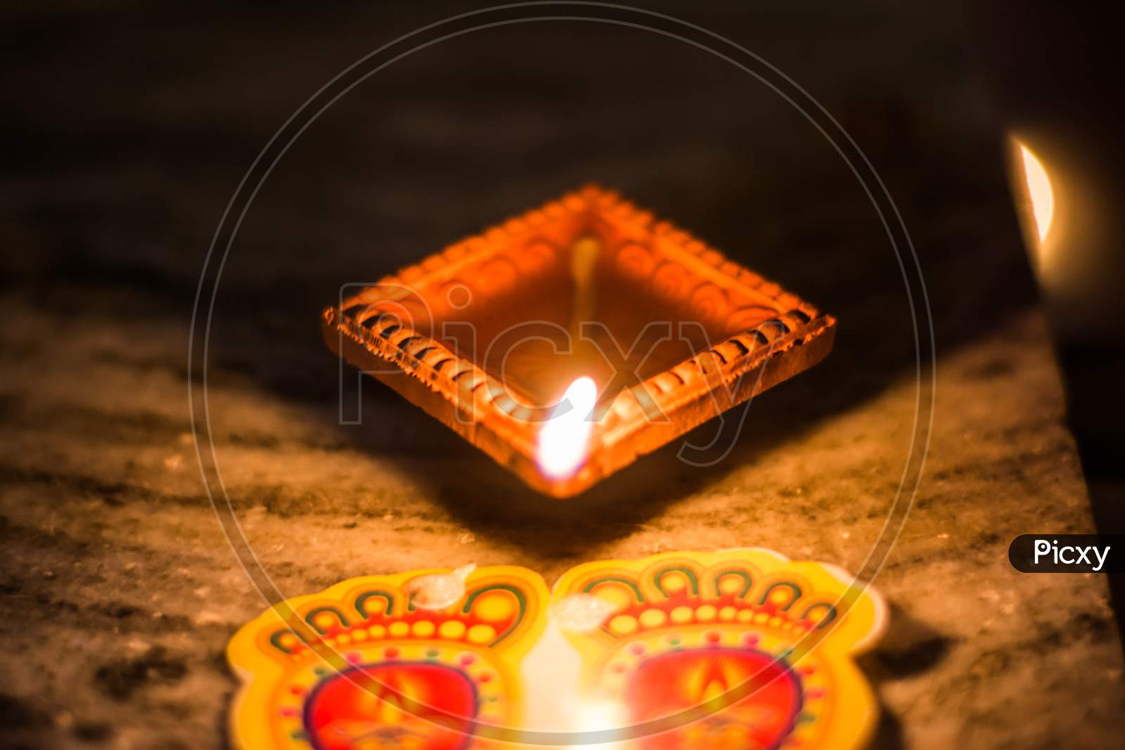 Happy Diwali - Colorful clay diya lamps lit during diwali celebration