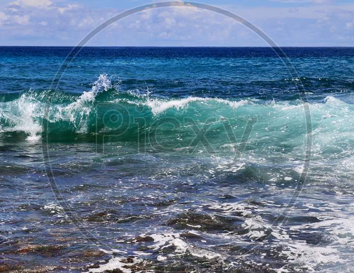 Beautiful splashing turquoise ocean waves at the white beaches on the paradise island Seychelles