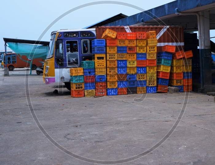 sea food logistics industry - plastic fish box and refrigerated  truck in harbor ,lock down covid 19