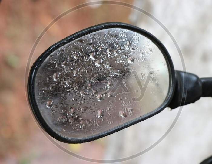 Side Mirror Of Motorcycle With Drops Of Rainwater And Covered Fog