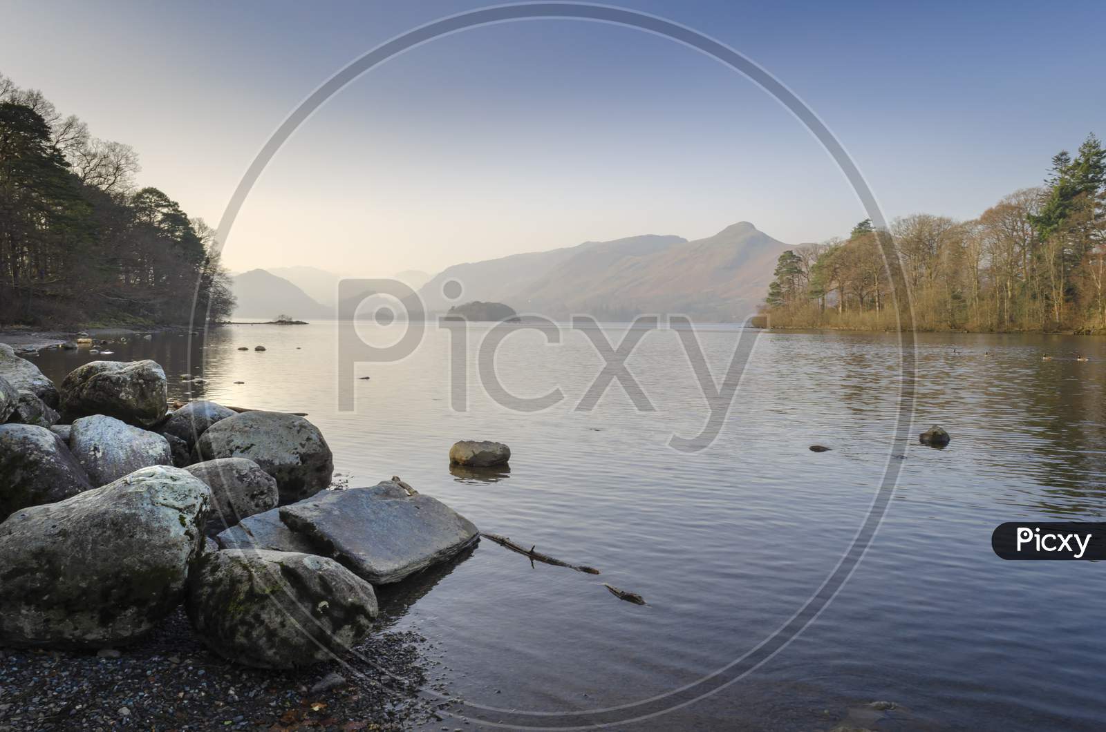 The Early morning still, calm water of Derwent water at Keswick in the Cumbrian Lake District in the North of England.
