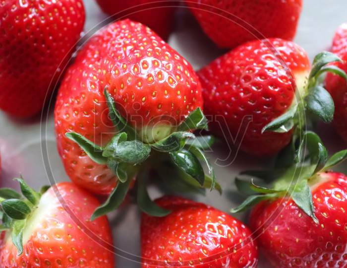 Close up on natural background of red strawberries ready for eating