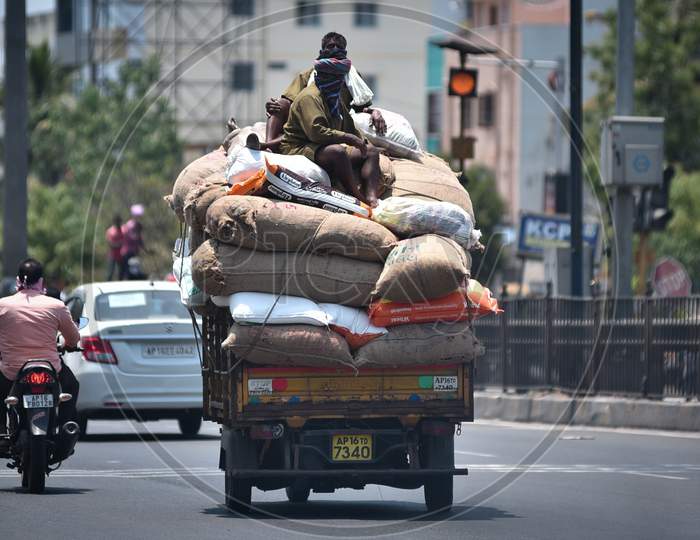 Labourers Travel Atop A Transport Vehicle Carrying Commodities During The Nationwide Lockdown Amid Coronavirus Pandemic In Vijayawada.