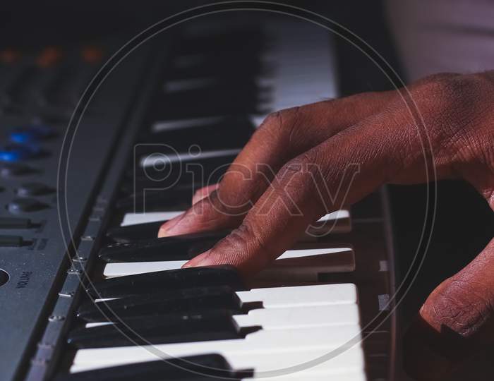 Playing The Electronic Keyboard In Music Recording Studio Close Up On Hands. Playing Electronic Piano.