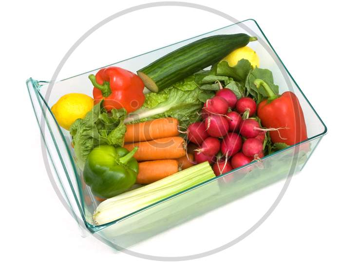 Refrigerator vegetable drawer full with a selection of vegetables