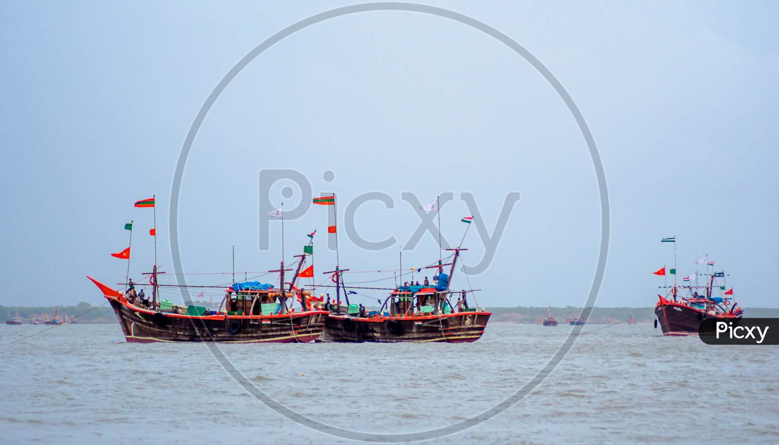 ferry boats sail on the sea from okha to dwarkadhish temple Gujarat India