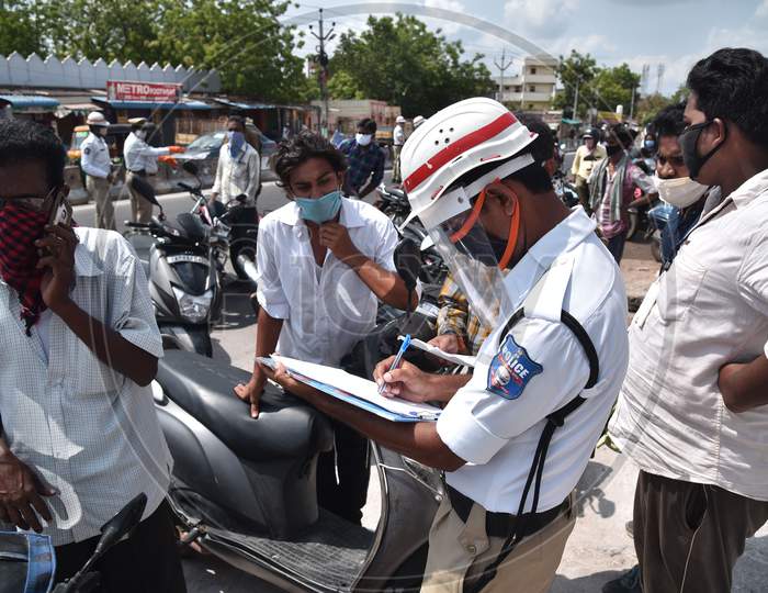 Traffic Police Personnel Stops The Commuters And Seeks An Explanation For Violating The Lockdown Norms During The Nationwide Lockdown Amid Coronavirus Pandemic In Vijayawada.