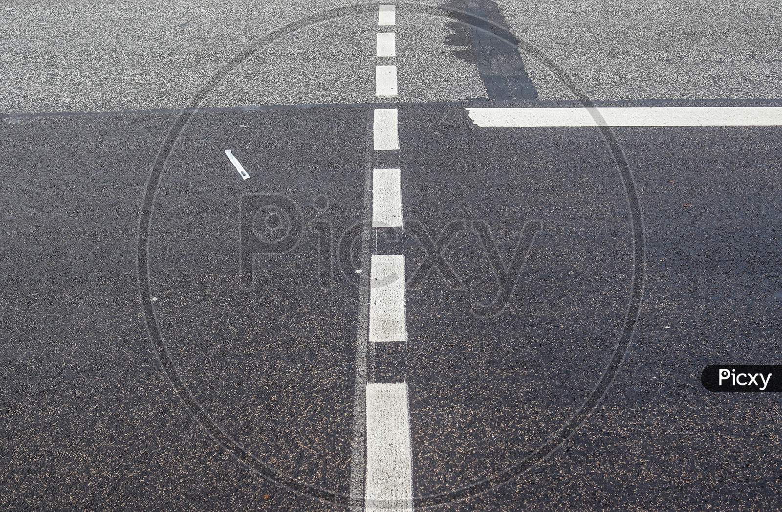 White lines and symbols on the asphalt of roads all over the world