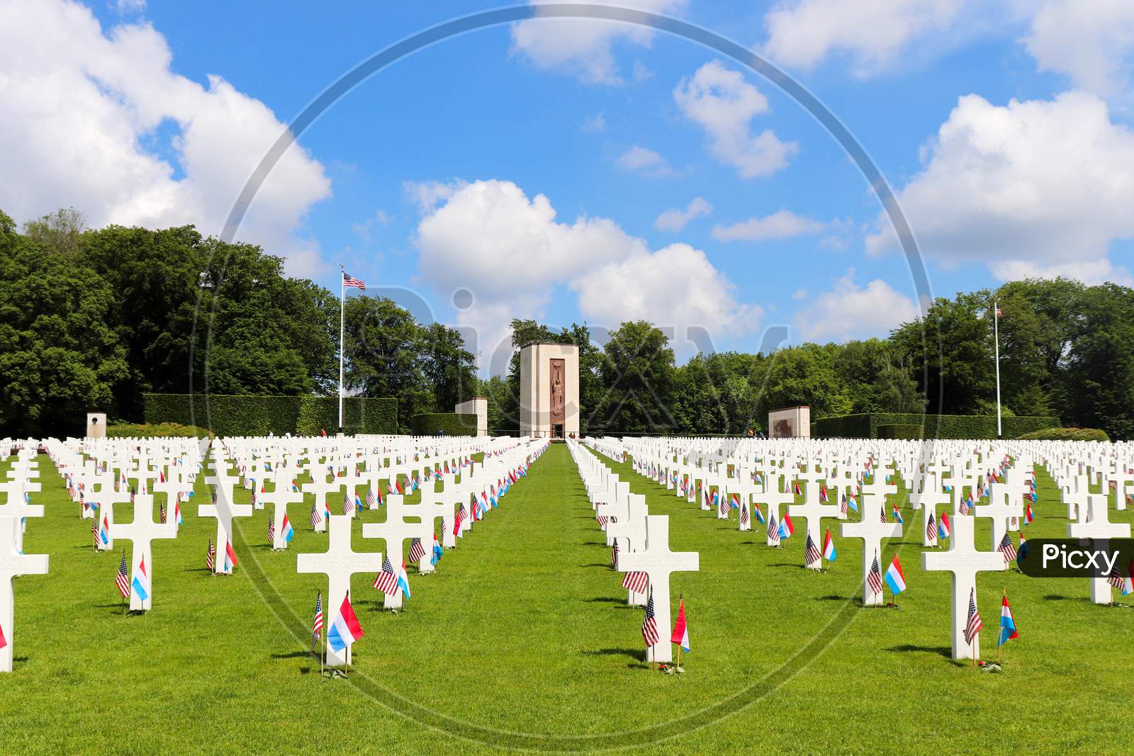 Rows Of Headstones At A Military Cemetery With A Chapel In The Backgound