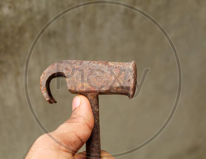 A Claw Hammer Held In Hand.