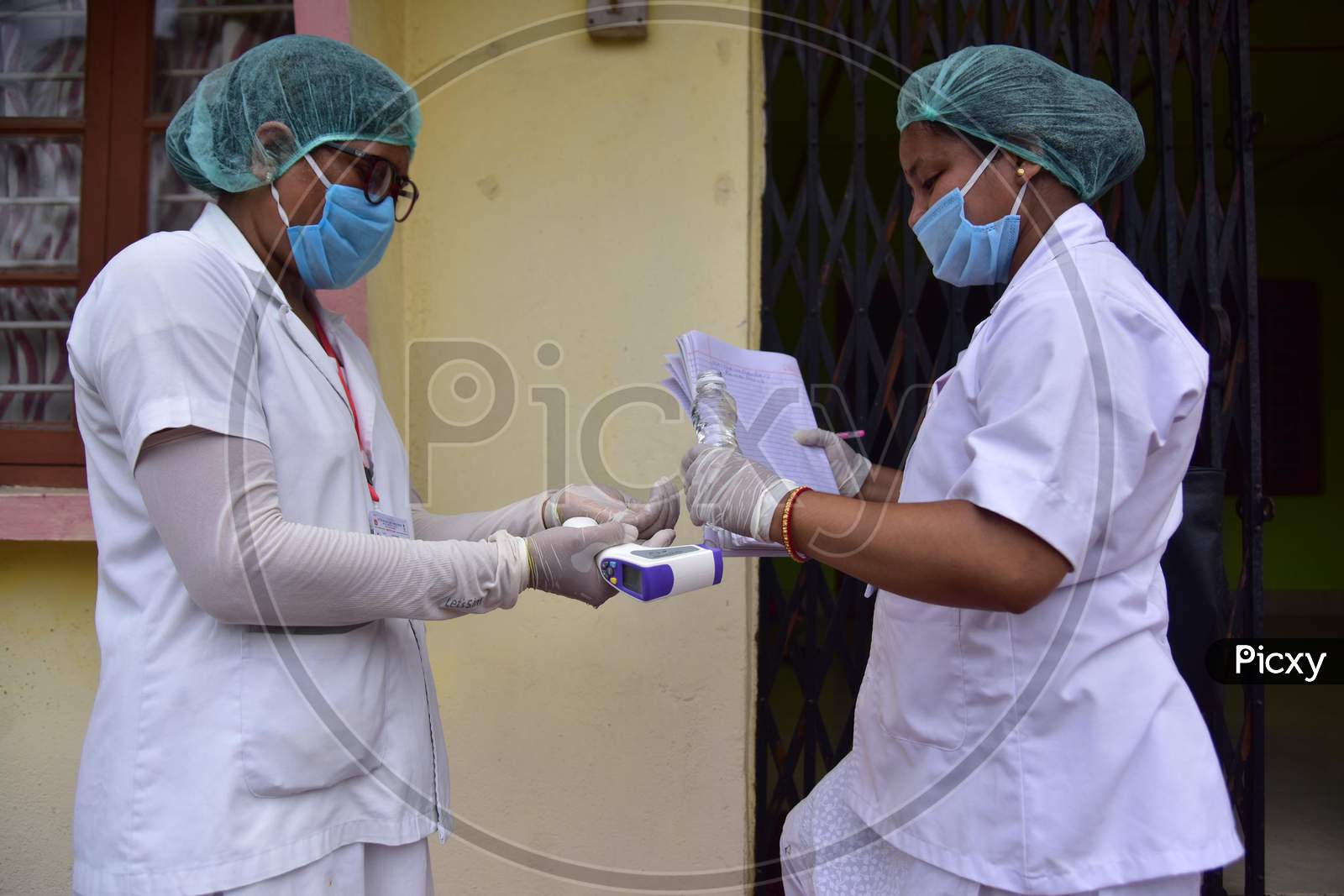 Health Worker Applies Sanitizer While Conducting  House To House Health Survey  House To House Health Survey  During Nationwide Lockdown Amidst Coronavirus or COVID-19 Pandemic  In Nagaon District Of Assam,India