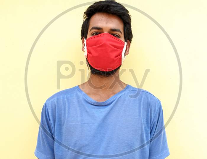 capture of a young man wearing a face mask to protect against the coronavirus during lockdown