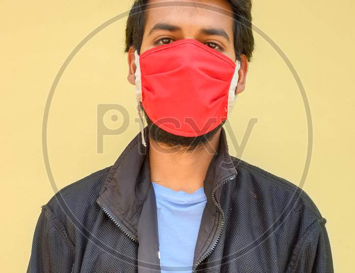 photo of a young man wearing a face mask to protect against the coronavirus during lockdown