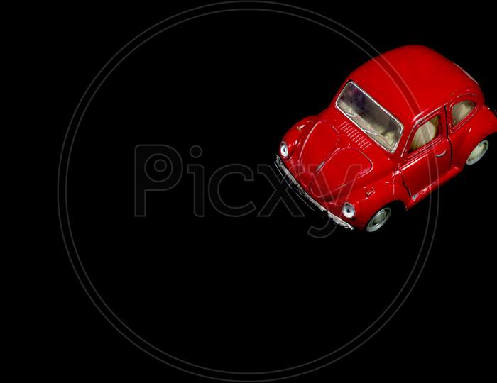 Children Toy, Old, Used, Rusted And Damaged Red Toy Car On Black Background