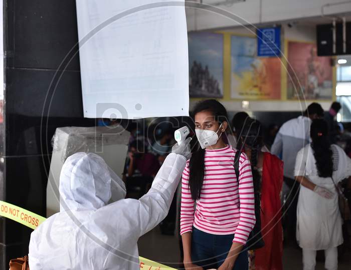 A Medic Conducts Thermal Scanning Of A Passenger On Her Arrival At Vijayawada Railway Station On A Special Train From New Delhi, During The Nationwide Lockdown Amid Coronavirus Pandemic In Vijayawada.