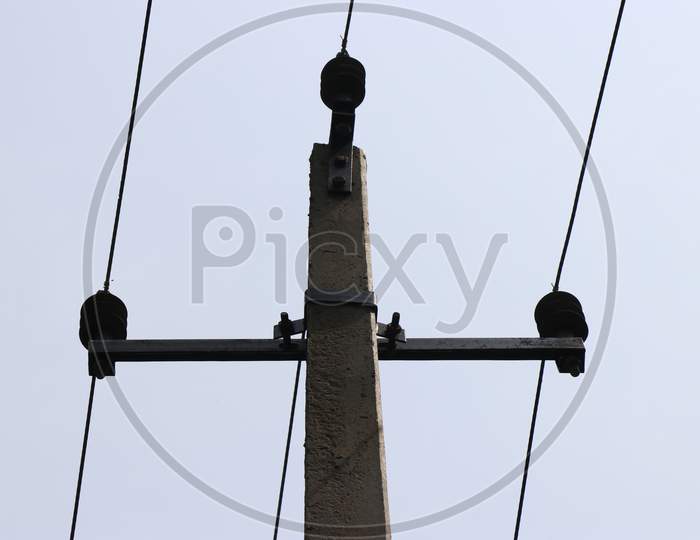 Electric Pole Made Of Concrete Carrying 3 Wires Which Gives Current Supply For Homes