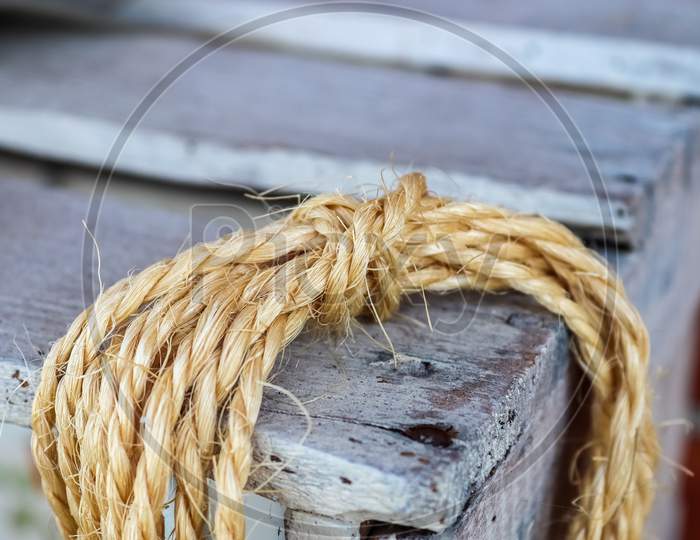 Old rope bound around an old vintage box in a close up view