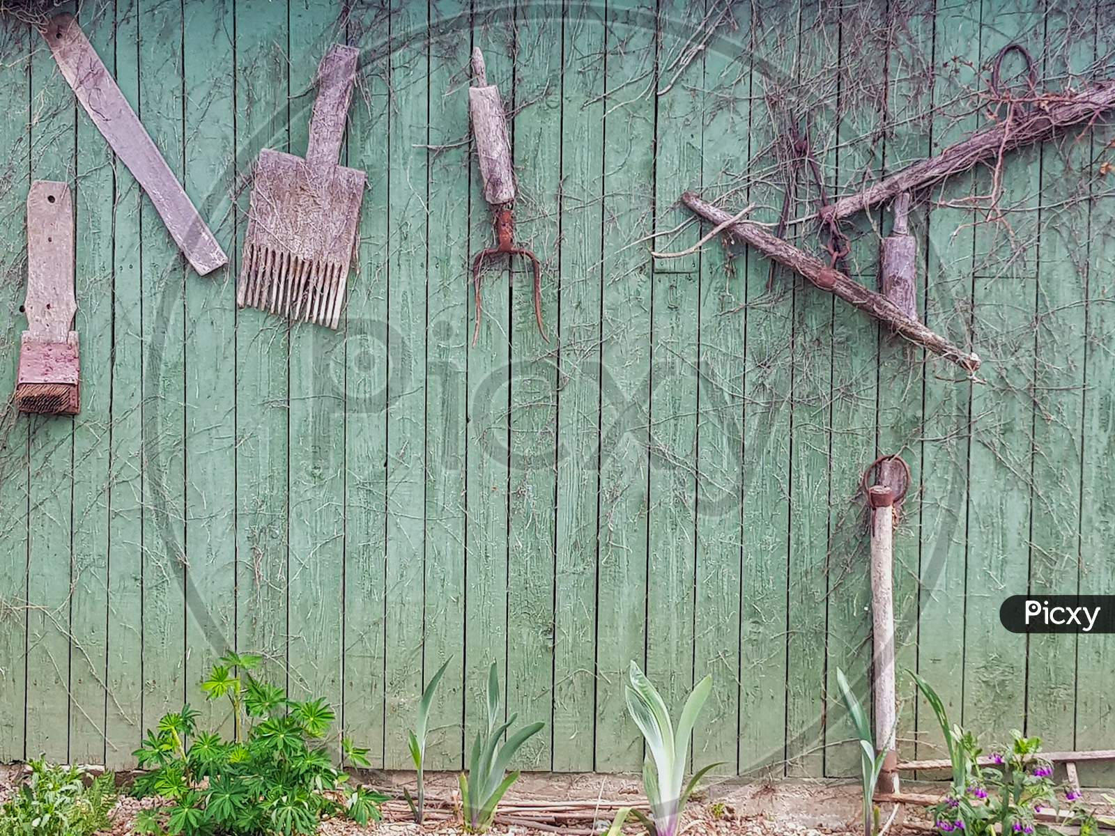 A Deceased Wall With Garden Tools Tagged in an House Garden