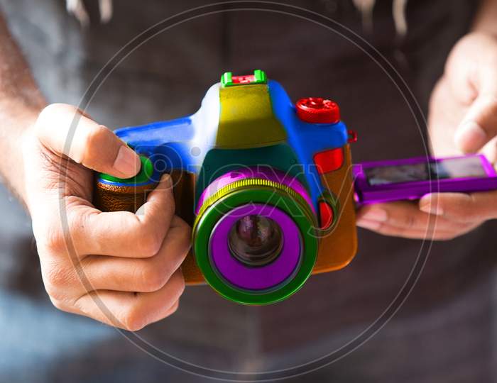 Closeup Of Man Hand Using Colorful Dslr Camera, Creativity Trendy Fashion Style.- Image