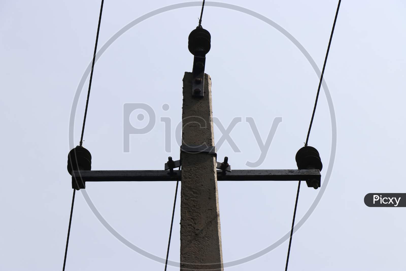 Electric Pole Made Of Concrete Carrying 3 Wires Which Gives Current Supply For Homes
