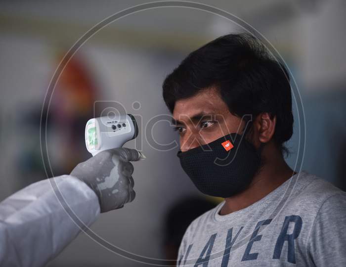 A Medic Conducts Thermal Scanning Of A Passenger On Their Arrival At Vijayawada Railway Station On A Special Train From New Delhi, During The Nationwide Lockdown Amid Coronavirus Pandemic In Vijayawada.