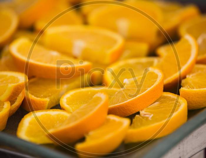 Lots Of Sliced Yellow Oranges In A Tray