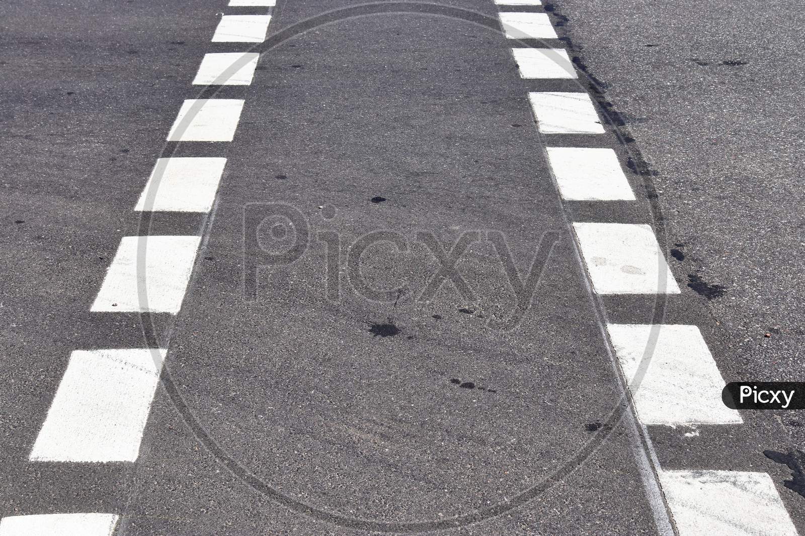 White lines and symbols on the asphalt of roads all over the world