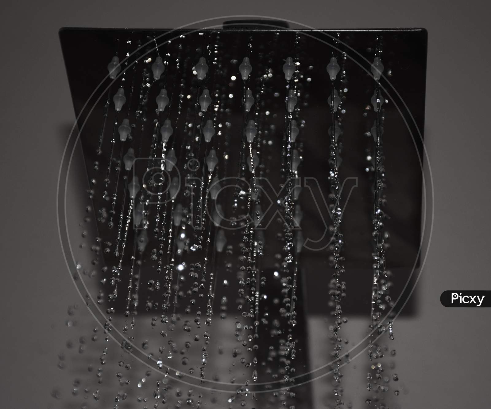 Closeup of a shower head with sprinkling or splashing water