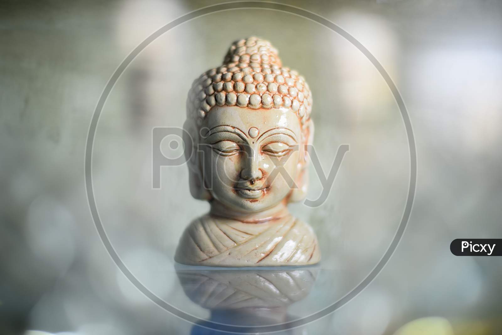Golden Buddha statue close up .Siddhartha bronze statue. Close up of Buddha beautiful serene face with closed eyes. Best meditation inspiration image or mindfulness background.Copy space.